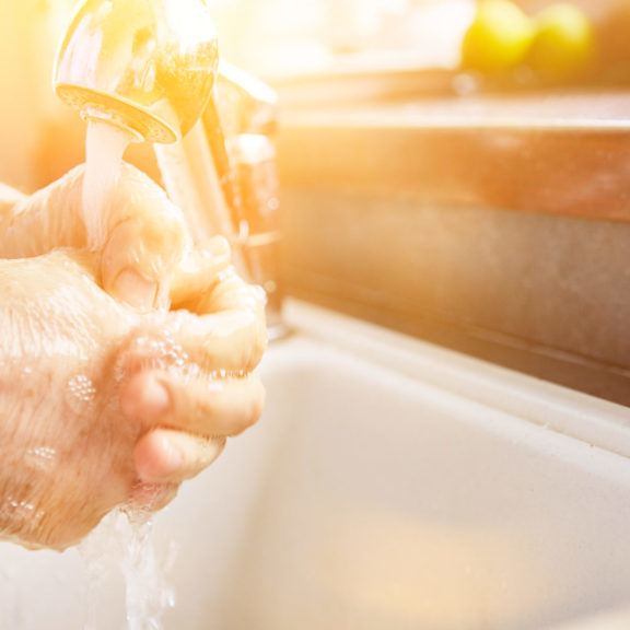 Elderly woman washing hands with soap in coronavirus epidemic